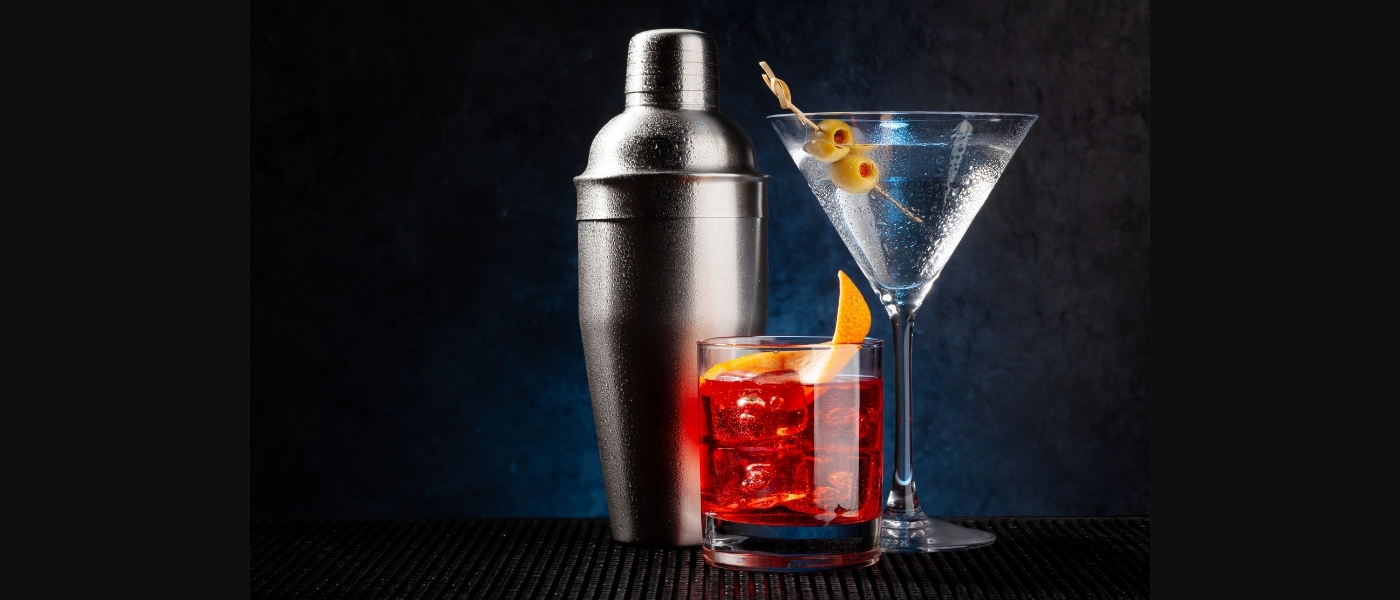 A cobbler shaker with two cocktails