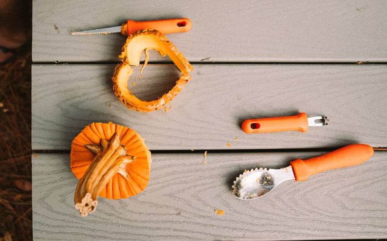 The pumpkin carving tools with pieces of a pumpkin