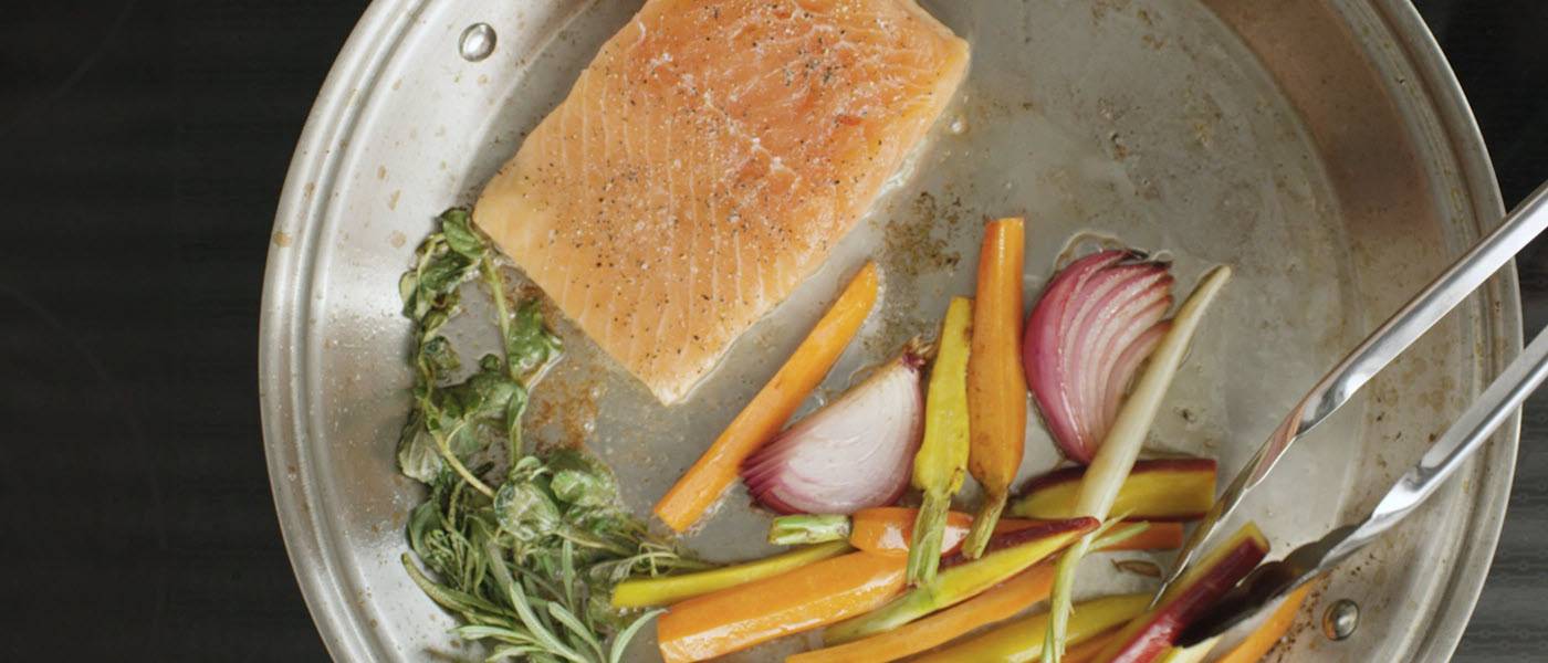 Salmon and carrots cooking in the Heritage Steel Paella Pan