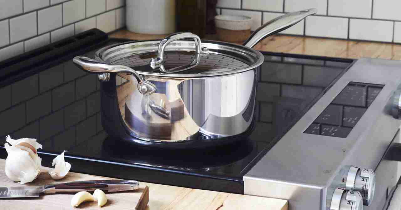 The Heritage Steel titanium series 4 quart saucepan with lid on a stovetop