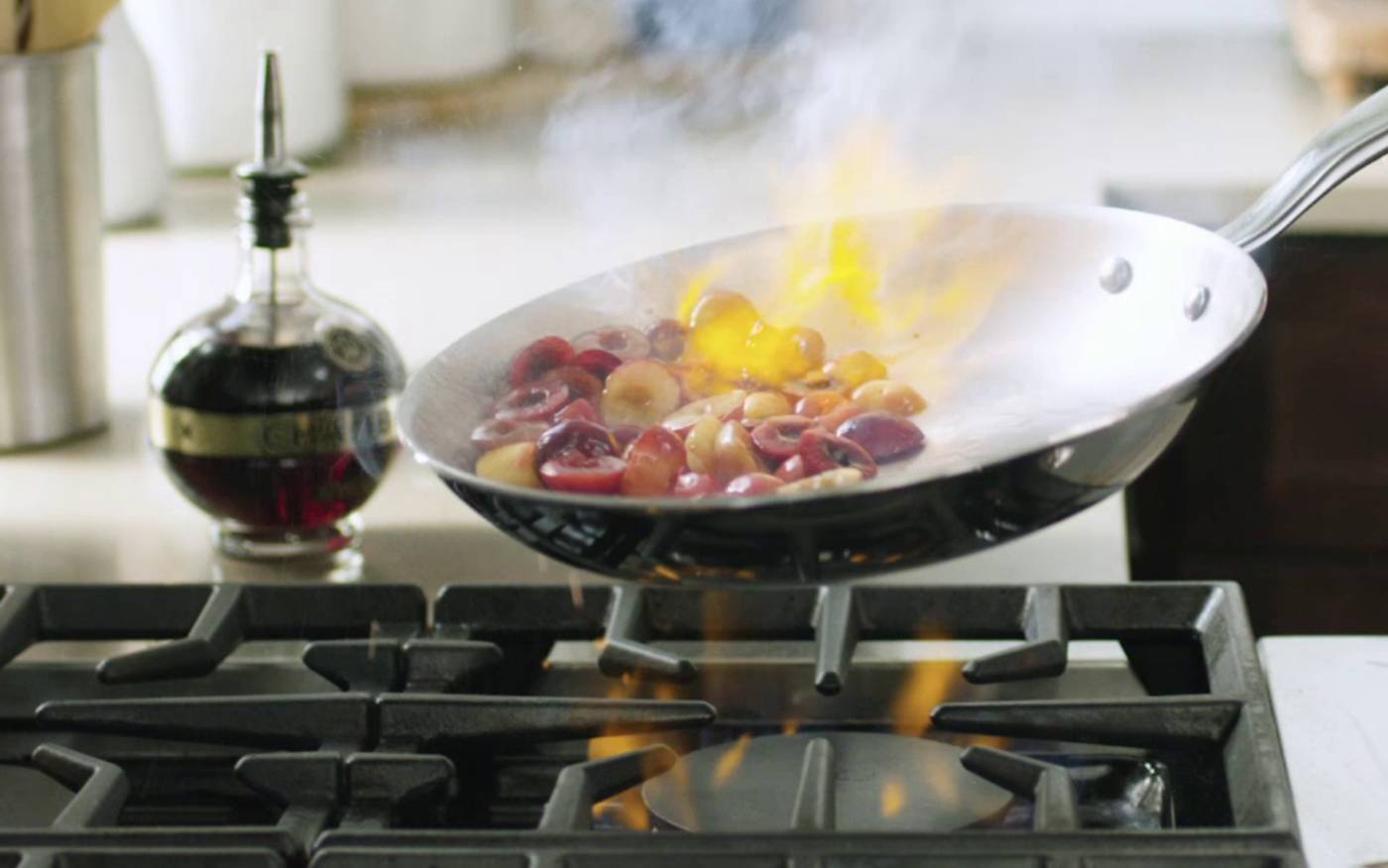 A Heritage Steel Titanium Series frying pan flambeing cherries