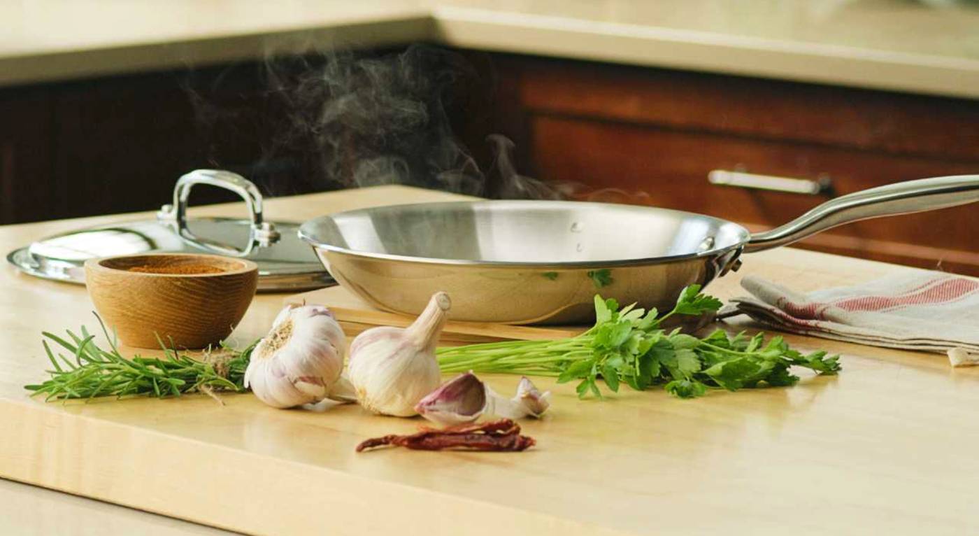 A Heritage Steel Titanium Series frying pan on the counter of a kitchen island