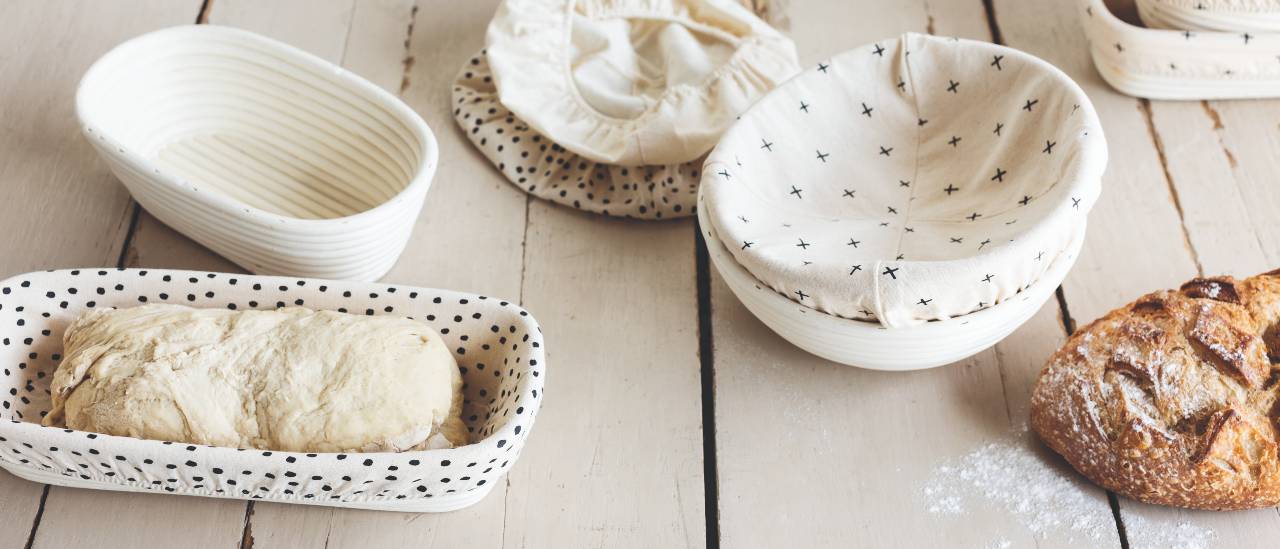 Now Designs Cotton Banneton Liners with banneton baskets and a loaf of bread