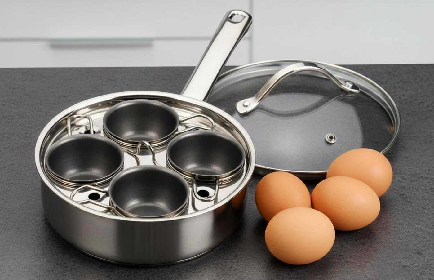 A RSVP International egg poacher with eggs on a kitchen counter